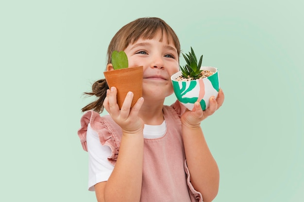 Cute girl with plants kid studio shoot