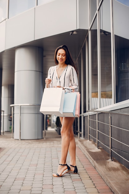 Cute girl with shopping bag in a city