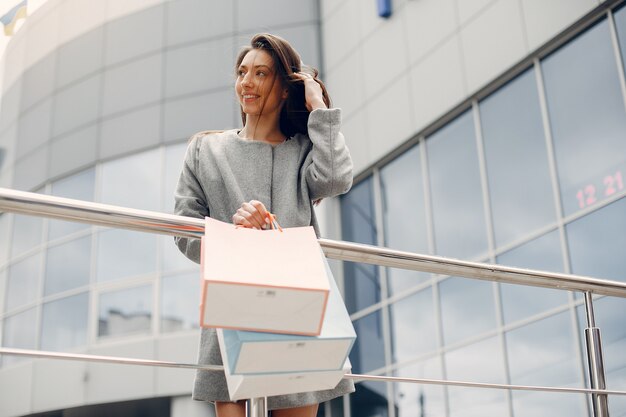 Cute girl with shopping bag in a city