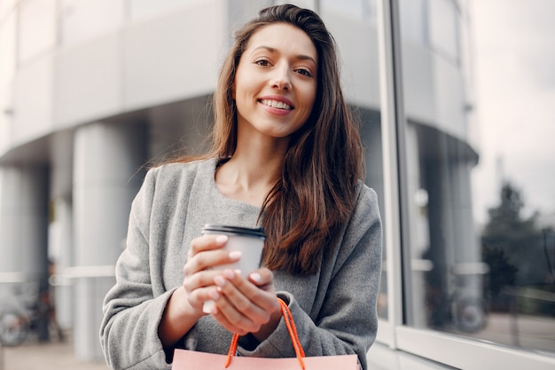 Cute girl with shopping bag in a city