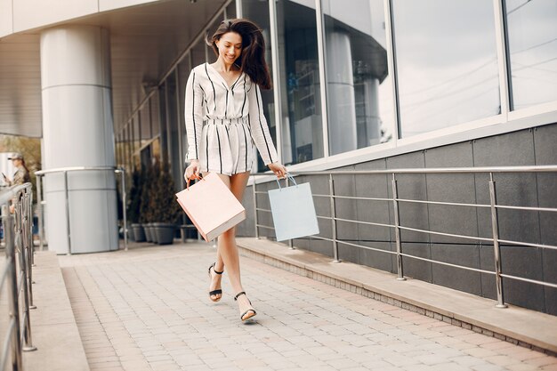 Cute girl with shopping bag in a city