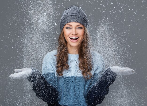 Cute girl with snowflakes having a good time