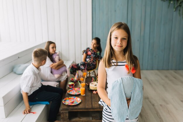 Free photo cute girl with soft toy on birthday party