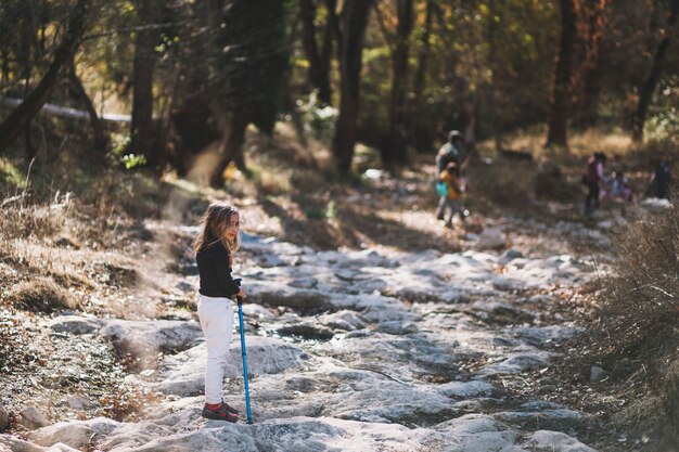 Cute girl with stick in forest