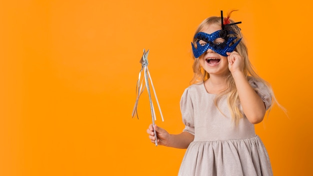 Cute girl with wand in costume