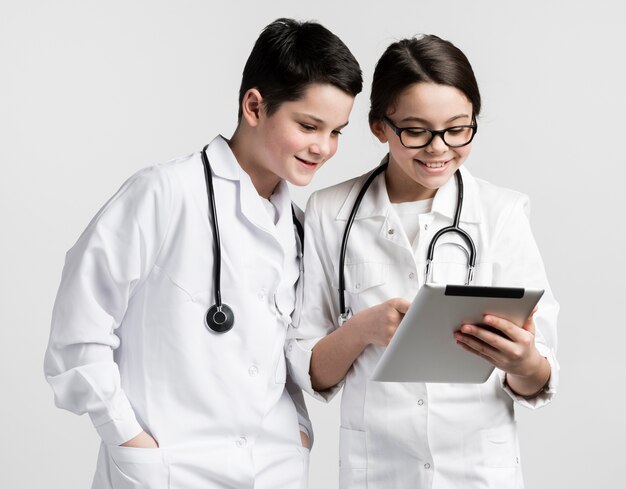 Cute girl and young boy dressed up as doctors