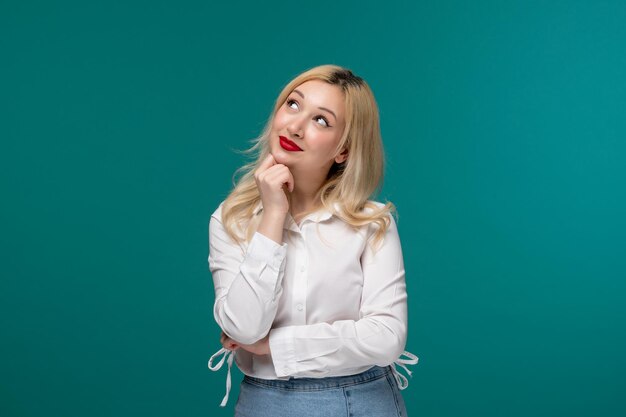 Cute girl young pretty blonde girl in a white shirt looking up and thinking of something