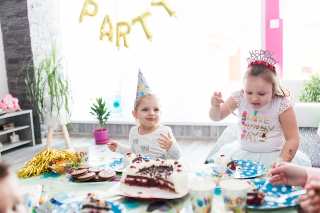 Cute girls eating cake