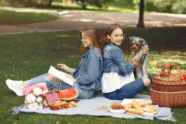 cute girls in a park playing with little dog