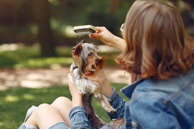 cute girls in a park playing with little dog