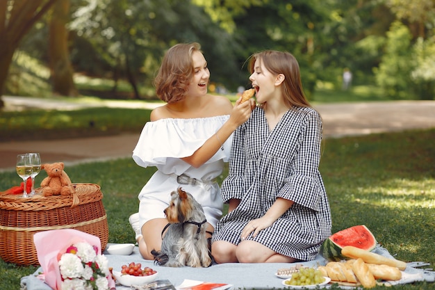 cute girls in a park playing with little dog