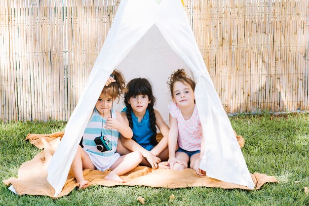 Cute girls sitting in tent