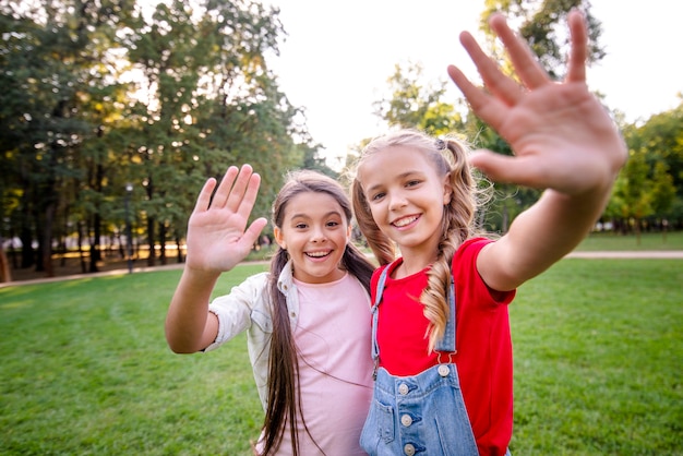 Cute girls waving at camera