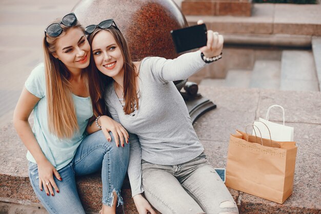 Cute girls with shopping bag in a city