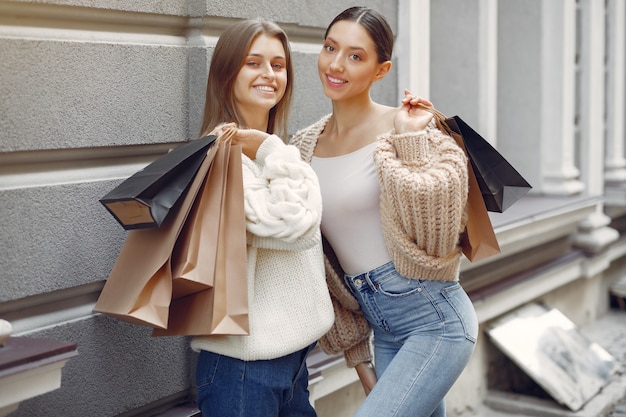 Cute girls with shopping bag in a city