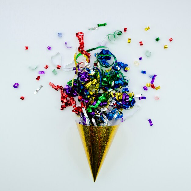 Cute golden cone filled with colourful ribbons