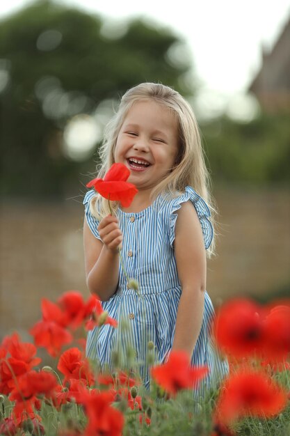 cute happy baby girl in hat and dress outdoor