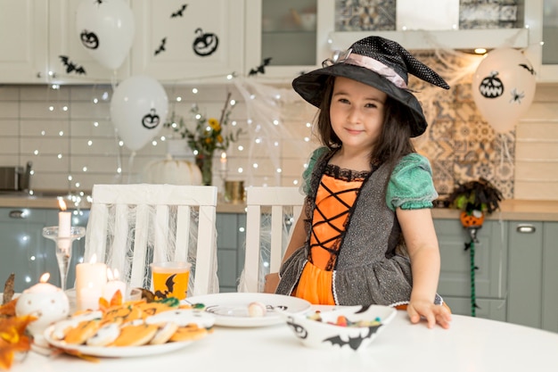 Cute and happy girl with witch costume