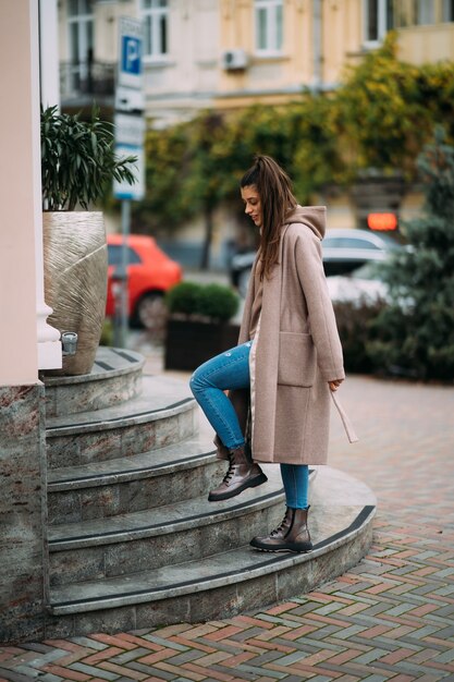 Cute happy smiling brunette walking around the city