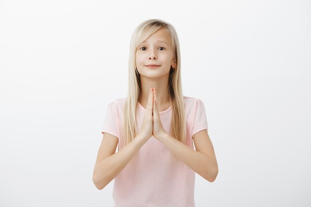 Cute hopeful little girl pleading, begging for new toy