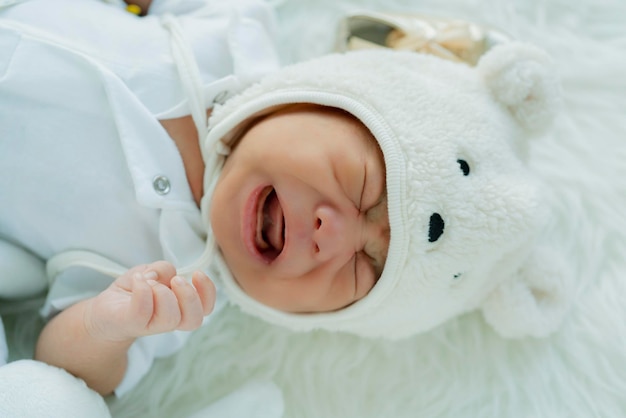 Cute infant baby boy sleep with sweet dream and peaceful white soft bed