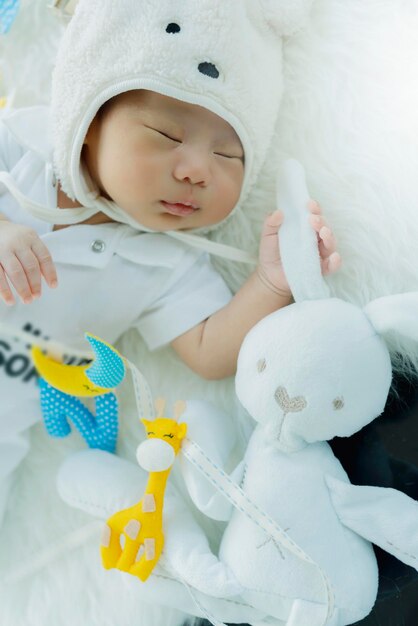 Cute infant baby boy sleep with sweet dream and peaceful white soft bed