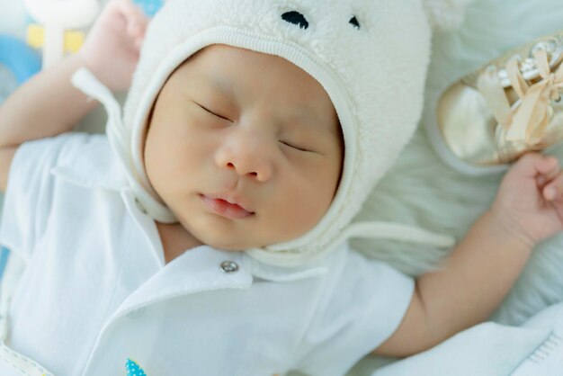Cute infant baby boy sleep with sweet dream and peaceful white soft bed