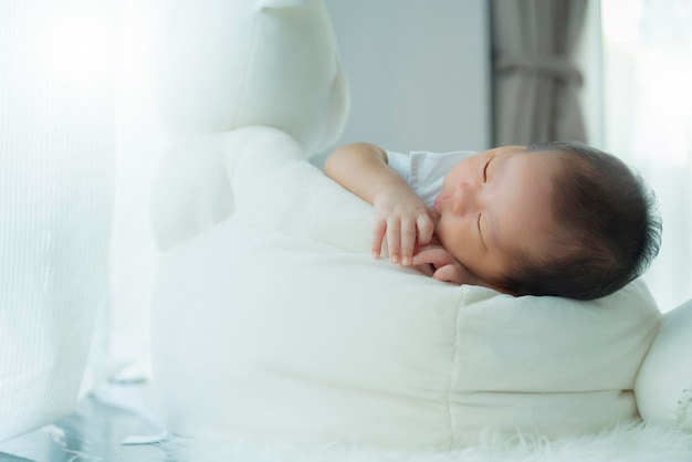 Free photo cute infant baby boy sleep with sweet dream and peaceful white soft bed