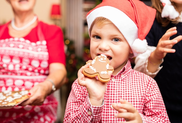 Cute kid biting a christmas cookie