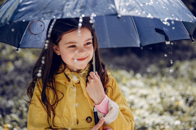 Cute kid plaiyng on a rainy day