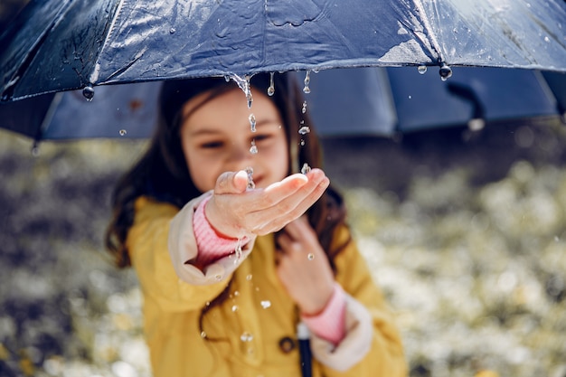 Cute kid plaiyng on a rainy day