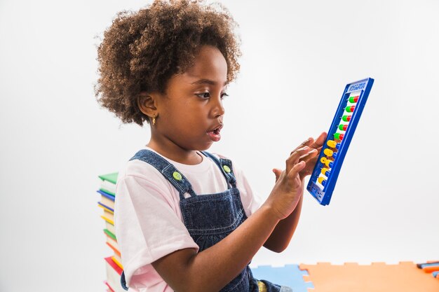 Cute kid with abacus in studio 