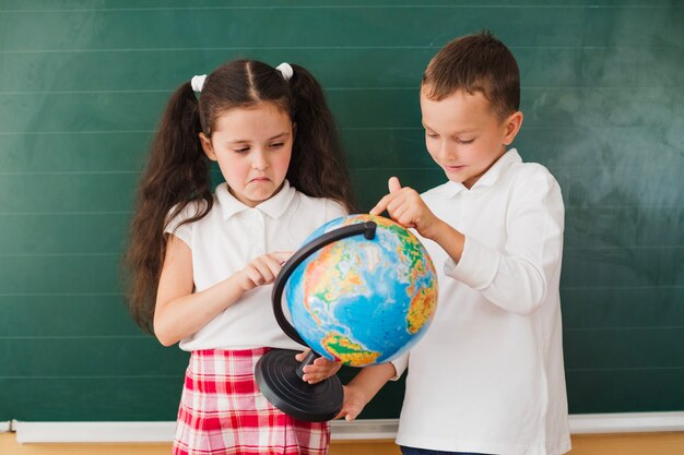 Cute kids holding globe