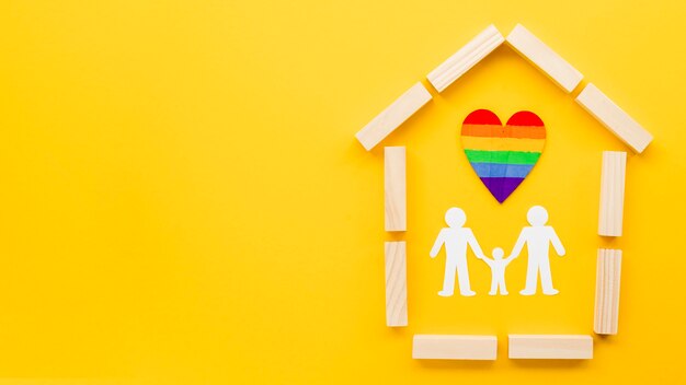 Cute lgbt family concept arrangement on yellow background with copy space