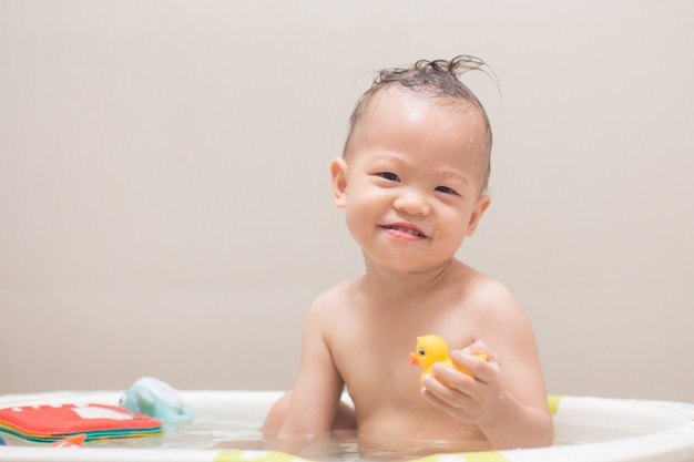 Young lass having fun in the bath