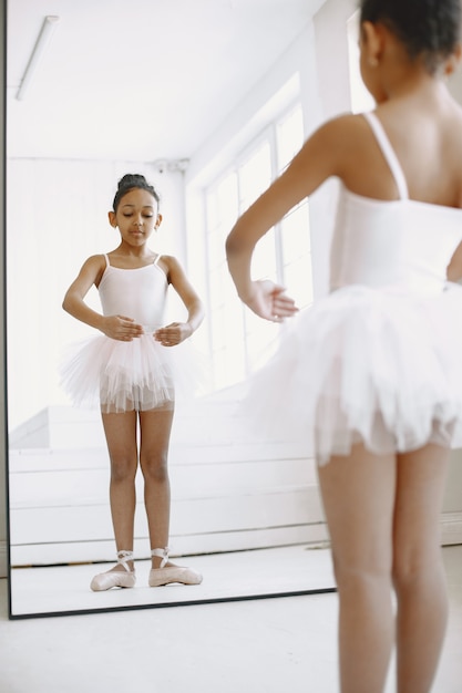 Free photo cute little ballerina. child dancing in the room. kid in dance class.