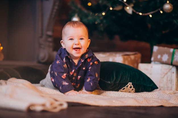 Cute little boy by the Christmas tree