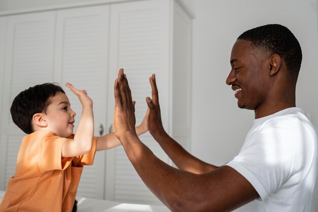 Cute little boy clapping hands with his dad