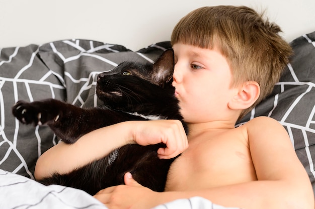 Cute little boy holding his kitten