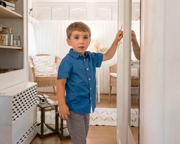 Cute little boy standing in a caravan