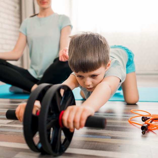 Free photo cute little boy training with mother at home