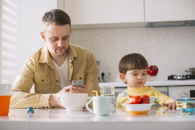 Cute little child and his father front view