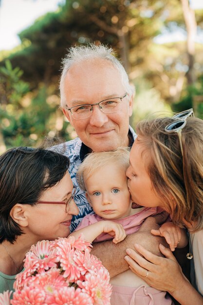 Cute little child with mother and grandparents