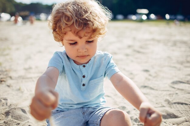 Cute little children playing on a sand