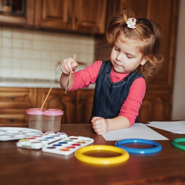 Cute little girl, adorable preschooler painting with watercolors