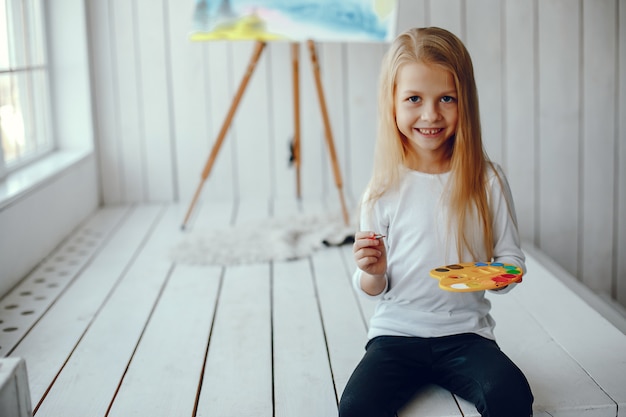 Cute little girl drawing in a studio