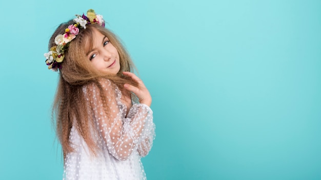 Cute little girl in flower wreath 