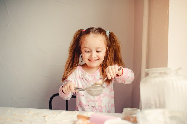 Cute little girl have fun in a kitchen