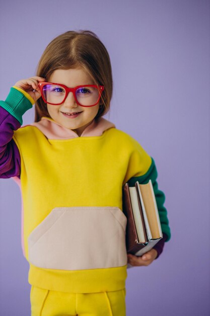 Cute little girl holding books isolated in studio