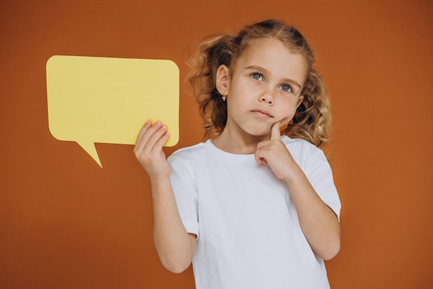 Free photo cute little girl holding mind bubbles isolated in studio